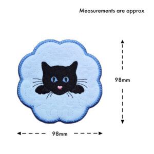Cat candle coaster size guide showing the embroidered black cat design with a scalloped blue border, measuring approximately 98mm x 98mm.