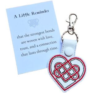 White Celtic Heart keyring with red and black embroidered knotwork design, shown with a matching keepsake card about love, trust and lasting connection.