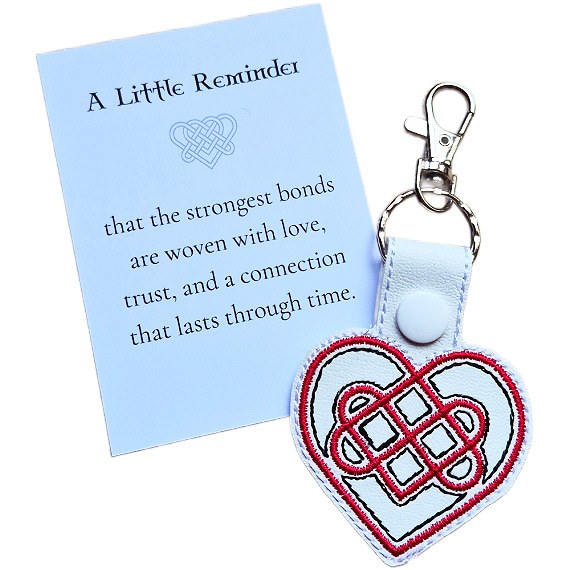 White Celtic Heart keyring with red and black embroidered knotwork design, shown with a matching keepsake card about love, trust and lasting connection.