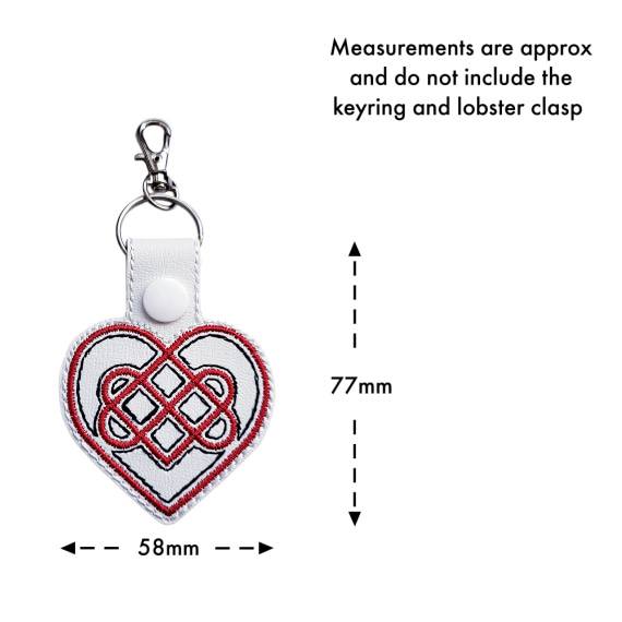 White Celtic Heart keyring with size guide showing approximate measurements of 77mm x 58mm, excluding the keyring and lobster clasp.