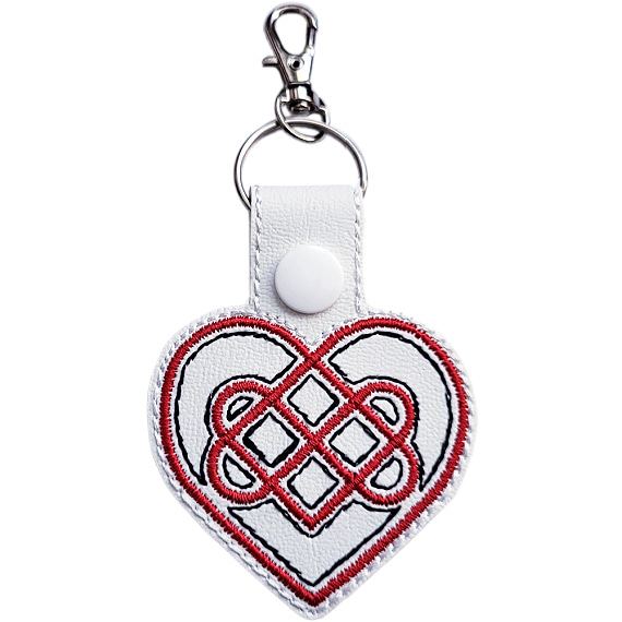 White Celtic Heart keyring with red and black embroidered heart knot design, white snap and silver metal clasp.