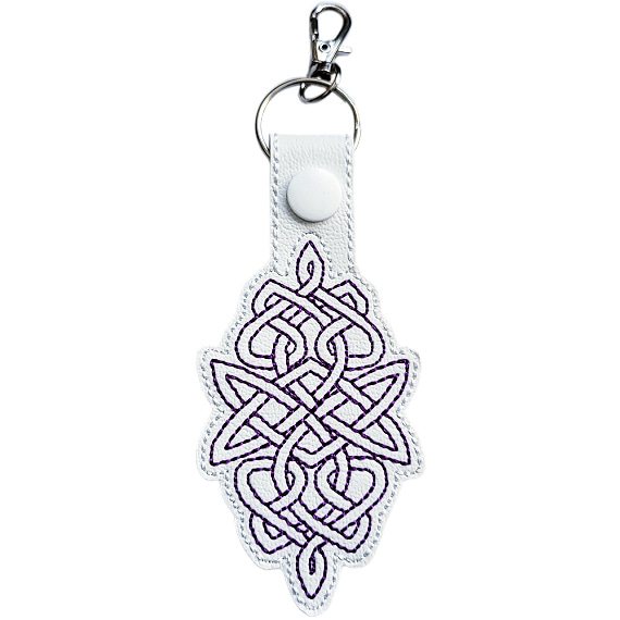 White Celtic Knot keyring with purple embroidered knotwork design, white snap and silver metal clasp.