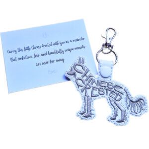 White embroidered Chinese Crested word art keyring with silver clip and matching keepsake card for dog lovers.