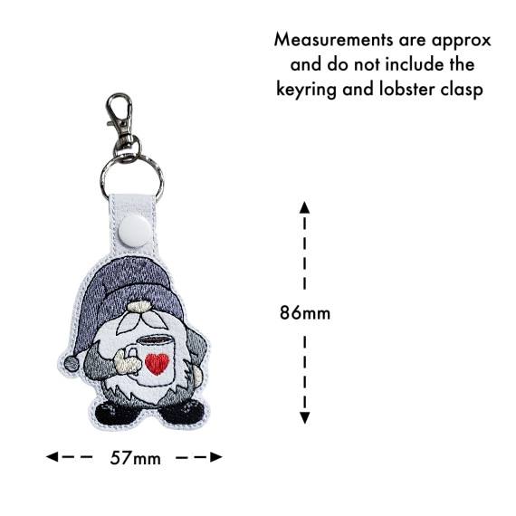 Embroidered coffee gnome keyring with size guide showing approximate measurements of 86mm by 57mm excluding the keyring and lobster clasp.