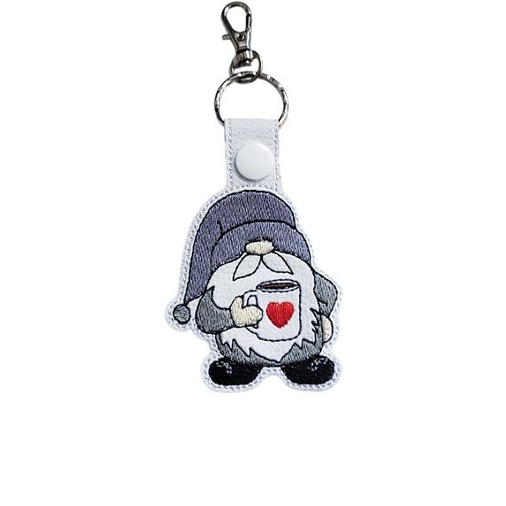 Embroidered coffee gnome keyring in faux leather, featuring a cosy gnome holding a cup with a heart and sturdy metal keyring hardware.
