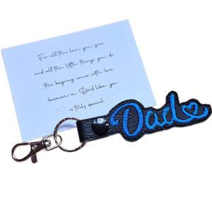 Black faux leather Dad Heart keyring with red embroidered Dad lettering and heart detail, shown with a keepsake card for a special Dad.