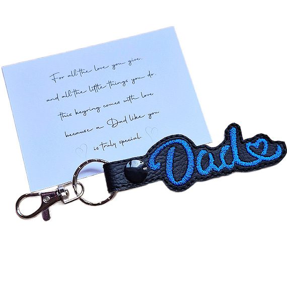 Black faux leather Dad Heart keyring with red embroidered Dad lettering and heart detail, shown with a keepsake card for a special Dad.
