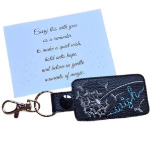 Black embroidered dandelion wish keyring with silver clip and matching keepsake card featuring a hopeful wish-themed message.