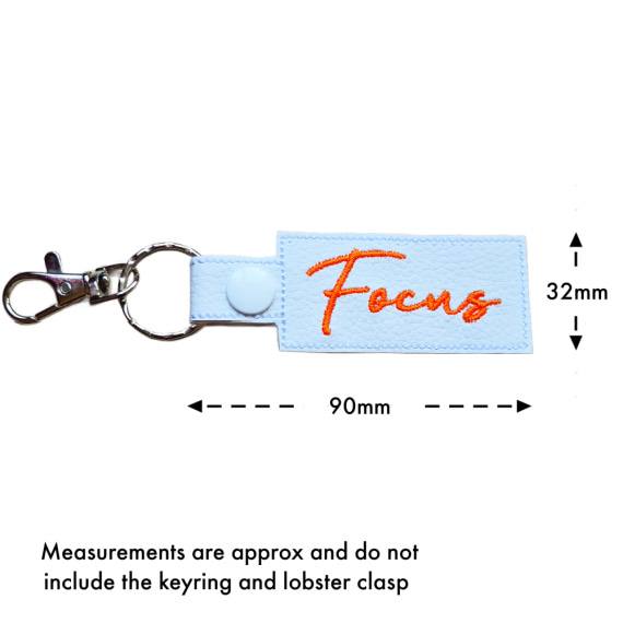 Embroidered Focus keyring with size guide showing approximate measurements of 90mm by 32mm excluding the keyring and lobster clasp.