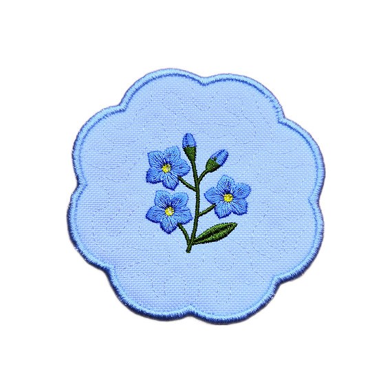 Embroidered forget me not candle coaster with a blue floral sprig in the centre, soft textured background and blue scalloped border.