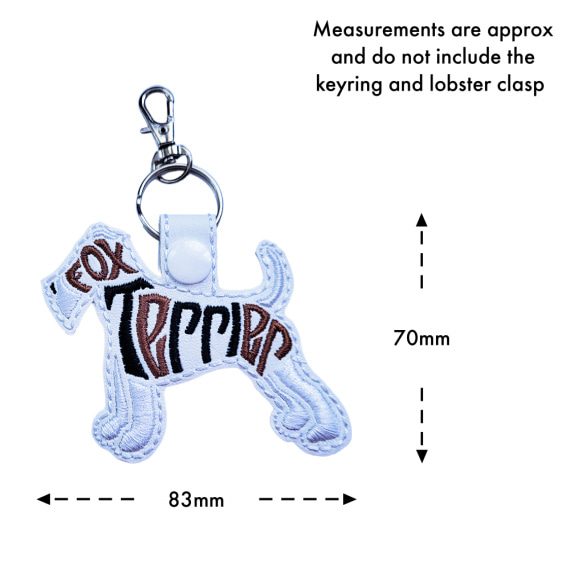 White Fox Terrier word art keyring with size guide showing the embroidered dog design measures approximately 70mm x 83mm, excluding the keyring and lobster clasp.