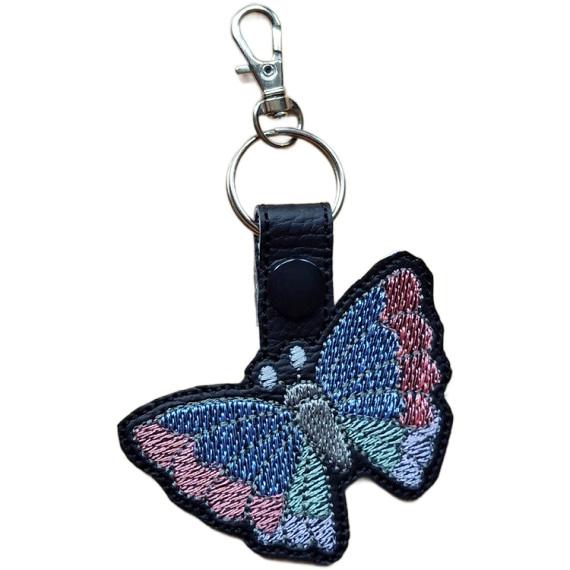 Black faux leather butterfly keyring with colourful embroidered wings, black snap and silver metal lobster clasp.