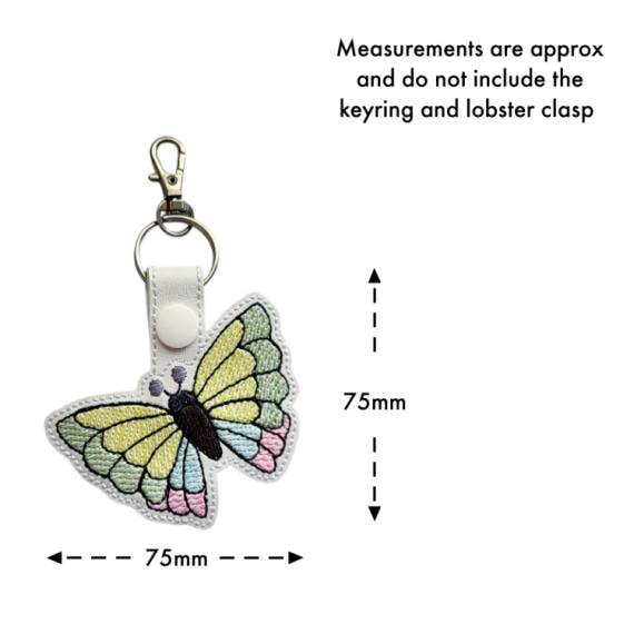 White faux leather butterfly keyring with size guide showing approximate measurements of 75mm x 75mm, excluding the keyring and lobster clasp.