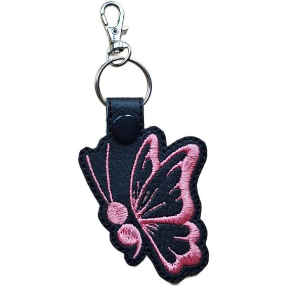 Black faux leather butterfly keyring with pink embroidered wing detail, black snap and silver metal clasp.