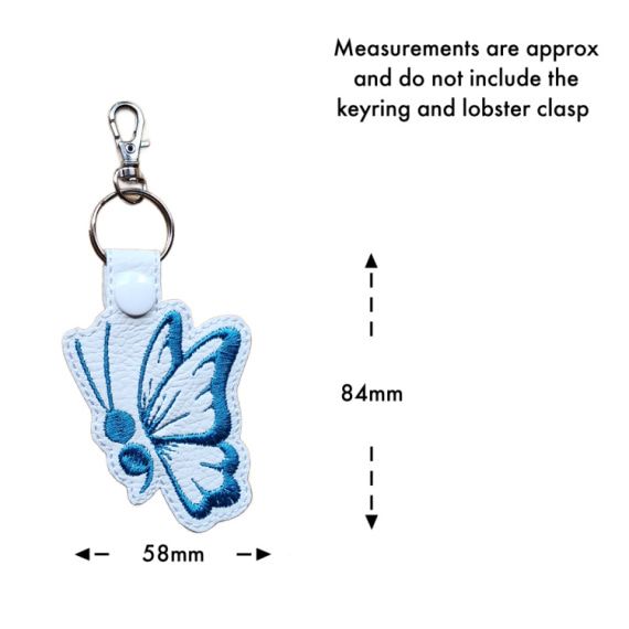 White faux leather butterfly keyring with size guide showing approximate measurements of 84mm x 58mm, excluding the keyring and lobster clasp.