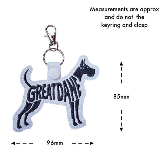 White Great Dane word art keyring with size guide showing the embroidered dog design measures approximately 85mm x 96mm, excluding the keyring and lobster clasp.