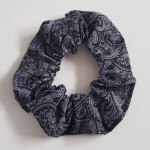 Grey and black paisley print fabric scrunchie on a white background.
