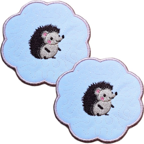 Set of two embroidered hedgehog candle coasters with cute stitched hedgehogs, scalloped edging and soft woodland style detailing.