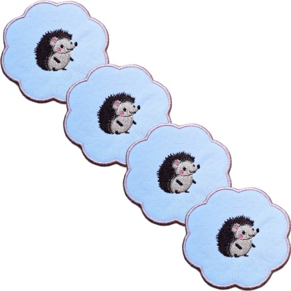 Set of four embroidered hedgehog candle coasters with cute stitched hedgehogs, scalloped edging and matching woodland style design.