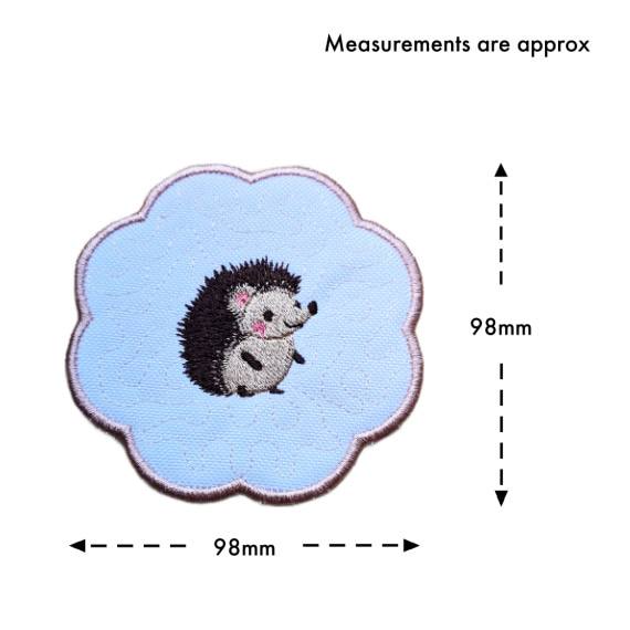 Hedgehog candle coaster size guide showing the embroidered scalloped coaster measuring approximately 98mm x 98mm.
