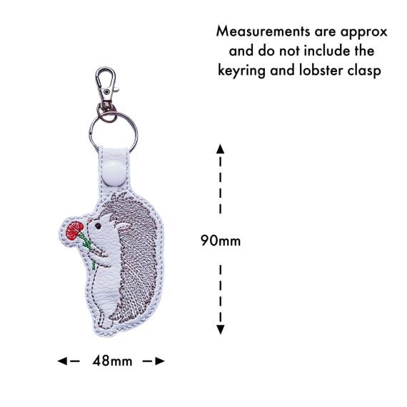 Embroidered hedgehog keyring with size guide showing approximate measurements of 90mm by 48mm excluding the keyring and lobster clasp.