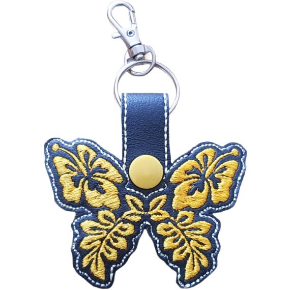Black faux leather hibiscus butterfly keyring with yellow floral embroidered wings, yellow snap and silver metal clasp.