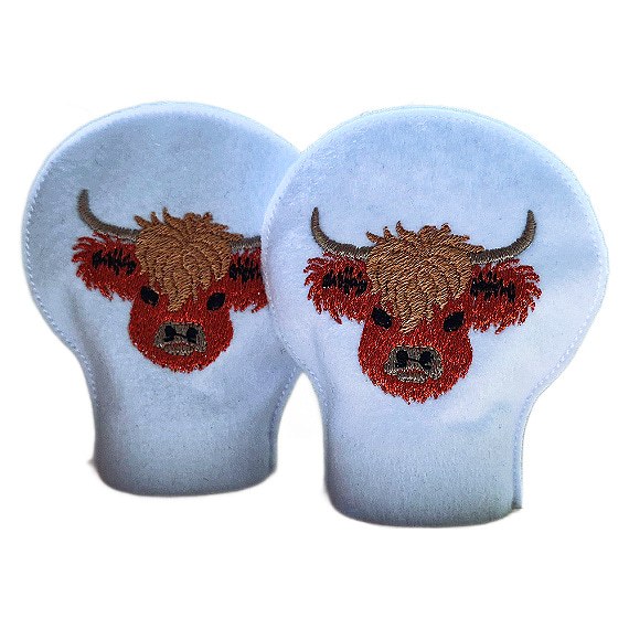 Pair of unlit embroidered Highland cow tealight covers made from soft felt, showing stitched Highland cow faces for a cosy farmhouse home display.