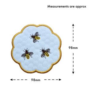 Honey bee candle coaster size guide showing the embroidered white fabric coaster with golden scalloped border, measuring approximately 98mm x 98mm.