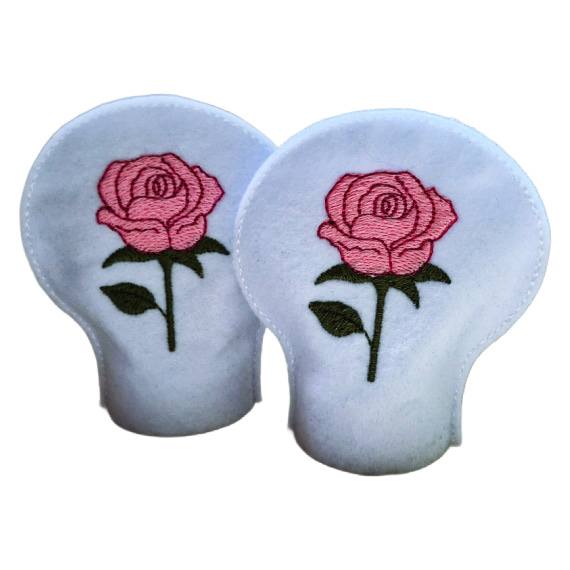 Unlit embroidered June birth flower tealight covers on white felt, with pink rose designs and green leaves, designed to fit over battery operated LED tealights.