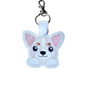 Kawaii Chihuahua keyring made from white faux leather, with embroidered big ears, sweet paws, pink ear detail and silver metal hardware.