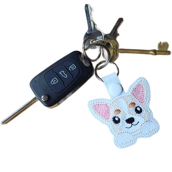 Kawaii Chihuahua keyring attached to a set of keys, showing the embroidered dog design in everyday use.