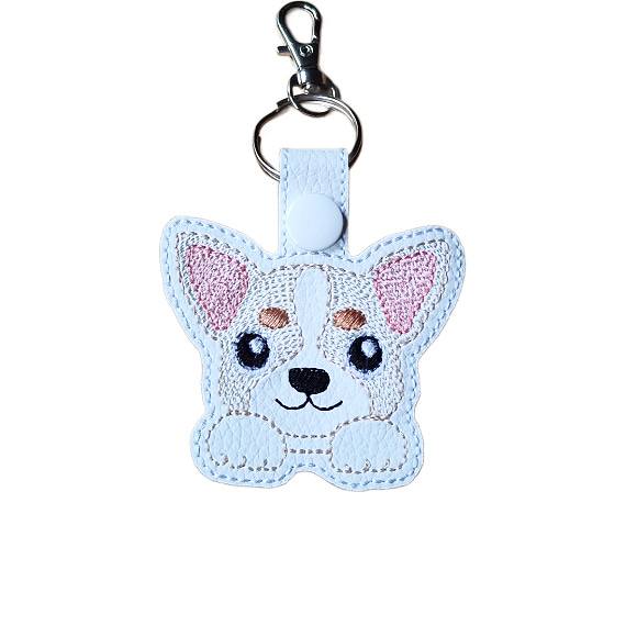 Kawaii Chihuahua keyring made from white faux leather, with embroidered big ears, sweet paws, pink ear detail and silver metal hardware.