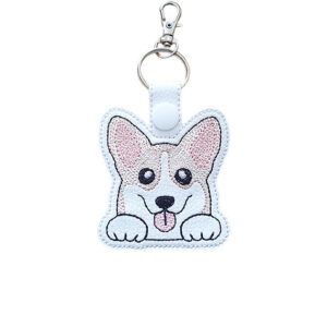 Kawaii Corgi keyring made from white faux leather, with embroidered perky ears, sweet paws, pink tongue and silver metal hardware.