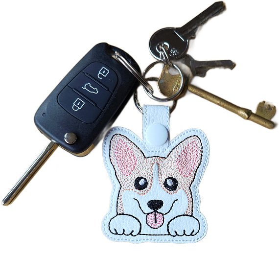 Kawaii Corgi keyring attached to a set of keys, showing the embroidered dog design in everyday use.