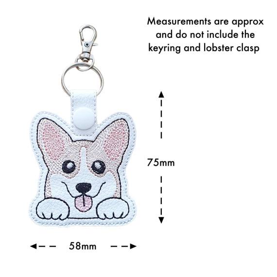 Kawaii Corgi keyring with size guide showing the embroidered dog design measures approximately 75mm x 58mm, excluding the keyring and lobster clasp.