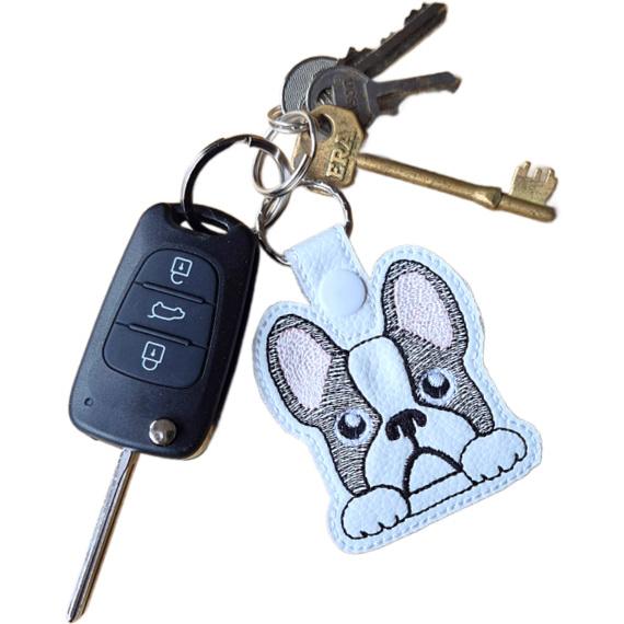 Kawaii French Bulldog keyring attached to a set of keys, showing the embroidered Frenchie design in everyday use.