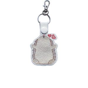 Embroidered Kawaii Hedgehugs keyring in faux leather, featuring a cute hedgehog with two red hearts and sturdy metal keyring hardware.