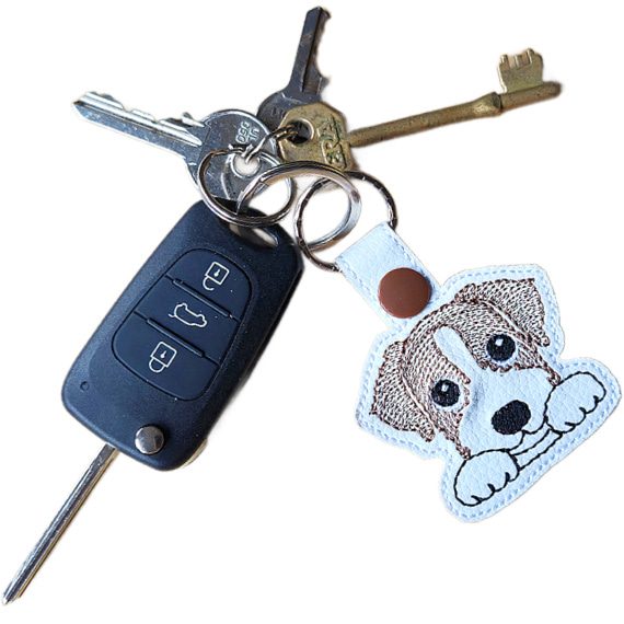 Kawaii Jack Russell Terrier keyring attached to a set of keys, showing the brown and white embroidered design in everyday use.