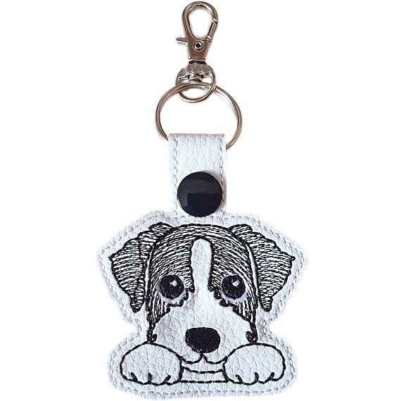 Long-haired Kawaii Jack Russell Terrier keyring in black and white, made from faux leather with embroidered details and silver metal hardware.