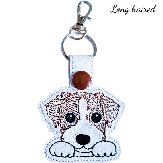 Long-haired Kawaii Jack Russell Terrier keyring in brown and white, made from faux leather with embroidered details and silver metal hardware.