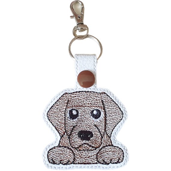 Kawaii Chocolate Labrador keyring made from white faux leather, with embroidered floppy ears, sweet paws and metal hardware.