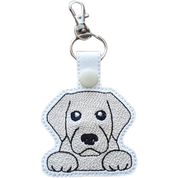 Kawaii Golden Labrador keyring made from white faux leather, with embroidered floppy ears, sweet paws and silver metal hardware.