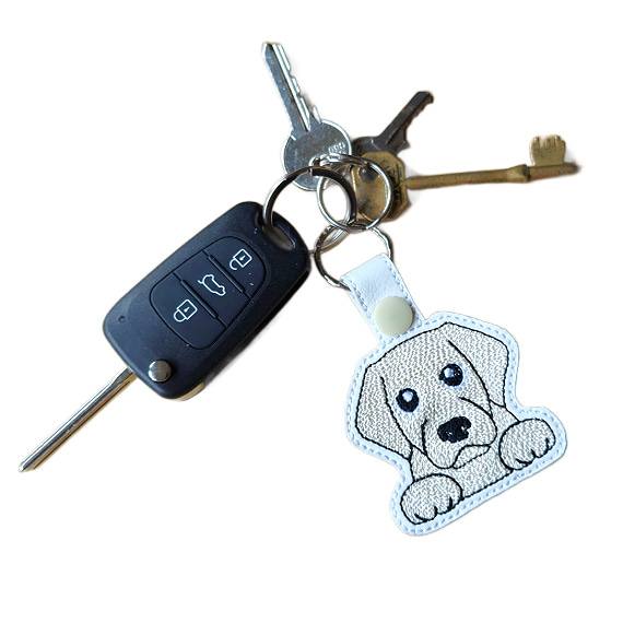 Kawaii Golden Labrador keyring attached to a set of keys, showing the embroidered dog design in everyday use.