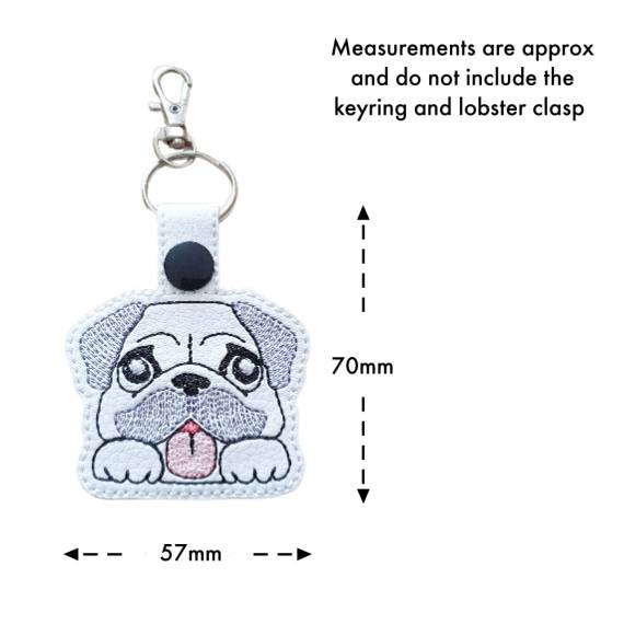 Kawaii Pug keyring with size guide showing the embroidered dog design measures approximately 70mm x 57mm, excluding the keyring and lobster clasp.