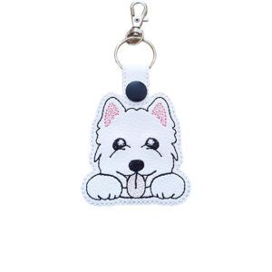 Kawaii West Highland Terrier keyring made from white faux leather, with embroidered fluffy face, pink ear detail, sweet paws and silver metal hardware.