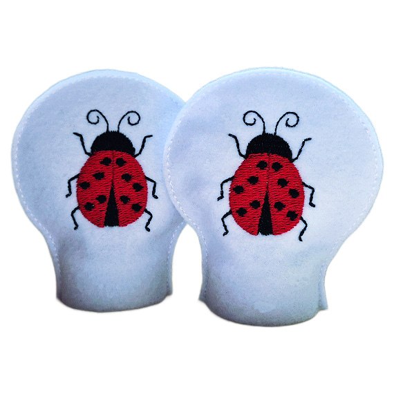 Pair of unlit embroidered ladybird tealight covers made from soft felt, showing bright stitched ladybirds for a cheerful garden inspired home display.