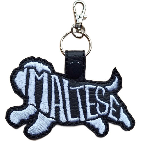 Black embroidered Maltese word art keyring made from faux leather, with stitched breed lettering and silver metal hardware.