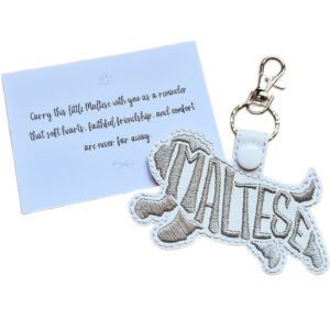 White embroidered Maltese word art keyring shown beside its keepsake card with a sentimental dog lover message.