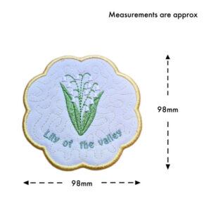 May birth flower candle coaster size guide showing the embroidered Lily of the Valley design with scalloped border, measuring approximately 98mm x 98mm.