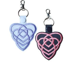 Black and white Motherhood Celtic Knot keyrings with embroidered heart knot designs and silver metal clasps.